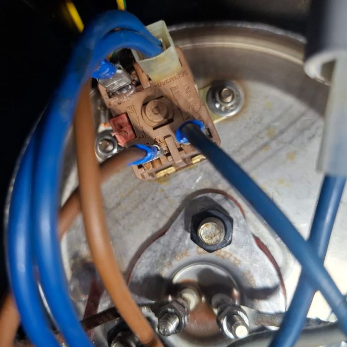 Wiring and thermostat on a heating element during an appliance repair